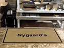 Custom Made Faux Coir Logo Mat Nygaards Fashions of New York