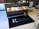 Custom Made Spectrum Logo Rug Rexius Nutrition of Omaha Nebraska