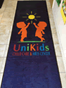 Custom Made Spectrum Logo Rug Unikids Daycare Center of Staten Island New York